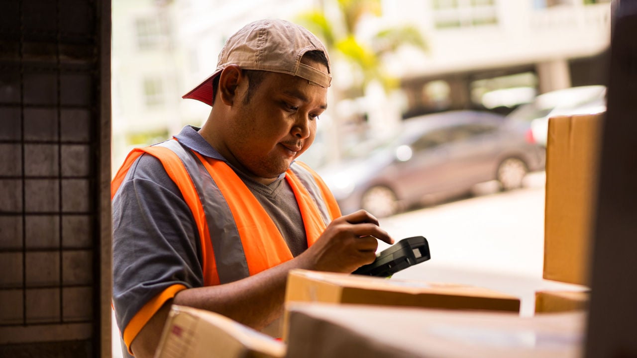 Man using handheld scanner in truck